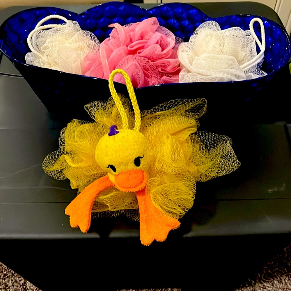 Brilliant blue tub with bath/shower wash loofah’s